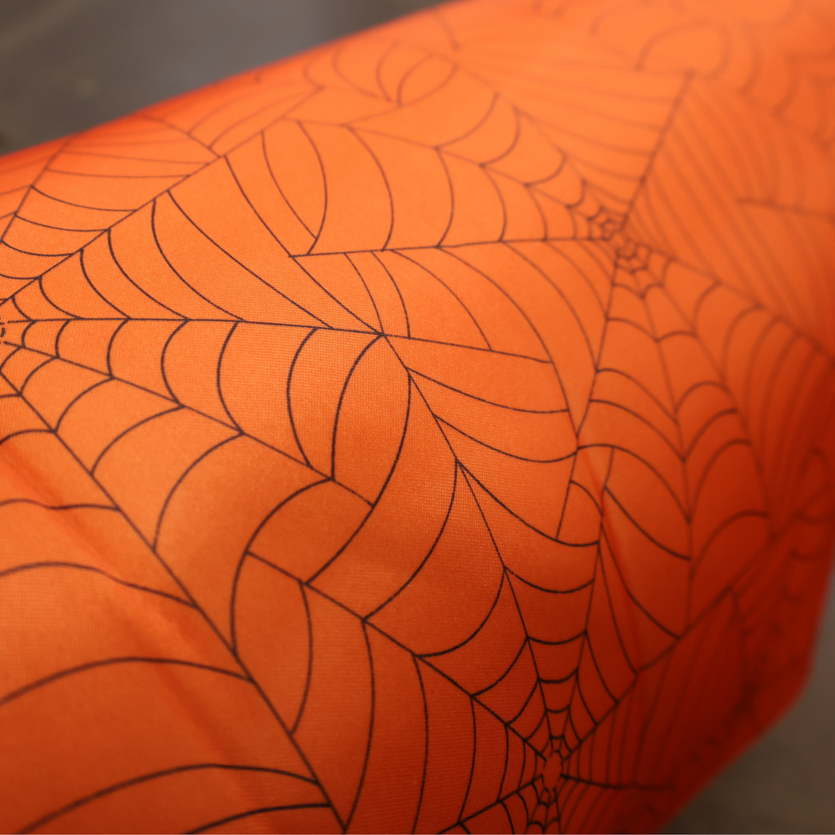 Halloween projects with this orange spider web fabric By Yard
